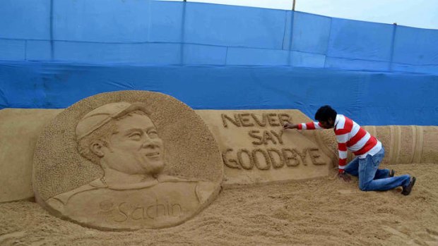 Indian sand artist Sudarsan pattnaik gives the final touches to his sand sculpture of Indian cricketer Sachin Tedulkar.