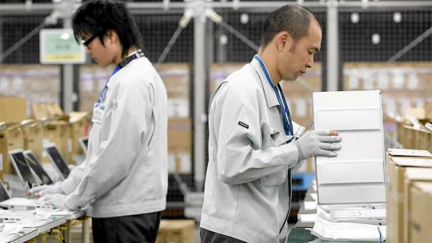 Workers at a Panasonic factory in Japan. A unit of Panasonic is reportedly under investigation for bribery.