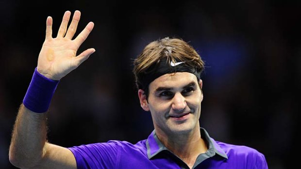 Roger Federer waves after defeating Spain's David Ferrer.
