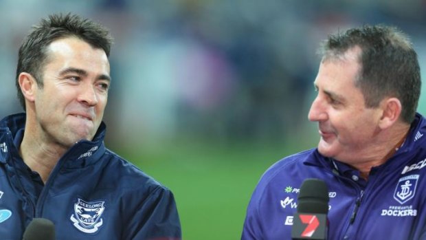 Ross Lyon (right) shares a laugh with Geelong coach Chris Scott during a pre-match interview on Saturday.