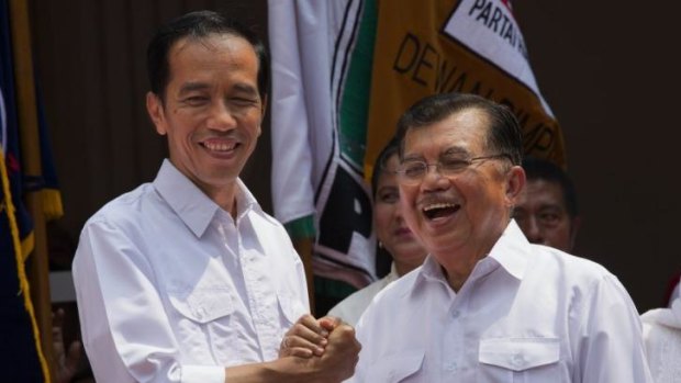 Indonesian presidential candidate Joko Widodo (left) announces his new running mate Jusuf Kalla.