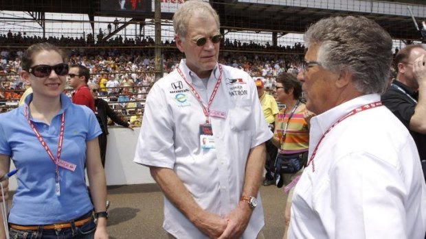 David Letterman, with assistant Stephanie Birkitt, talks to Mario Andretti before the start of the 2007 Indianapolis 500.