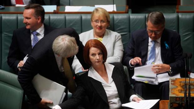 Getting on with the job ... Kevin Rudd and Julia Gillard confer during question time yesterday.