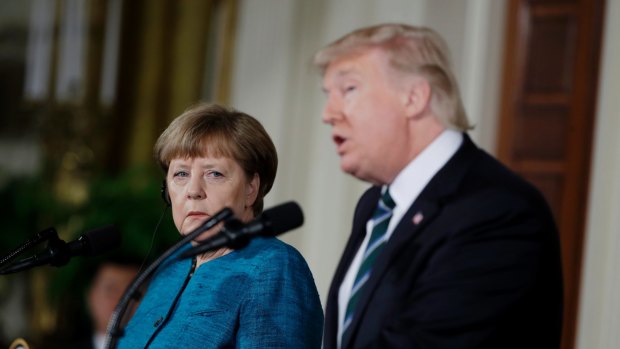German Chancellor Angela Merkel listens as President Donald Trump speaks during their joint news conference.