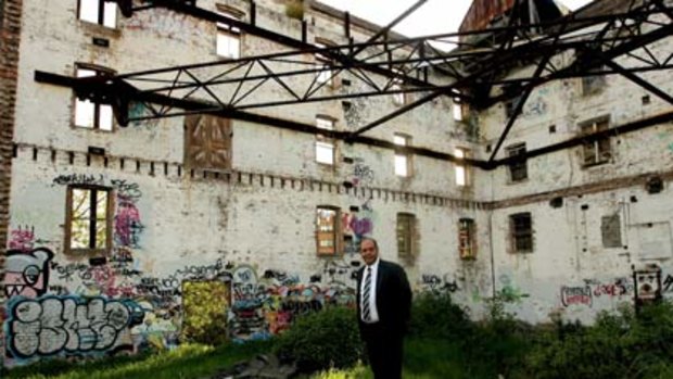 Heritage-listed eyesore... Mike Boulos inside the 113-year-old graffiti-daubed flour mill that was  listed by the National Trust.