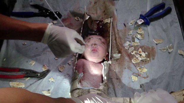 The newborn baby boy was rescued from a sewage pipe in a Chinese apartment building.
