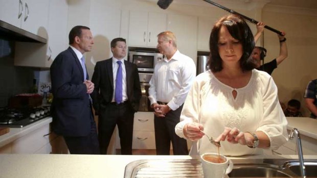 Deb Schmusch makes a cup of tea for Tony Abbott during his visit to her home in Adelaide.