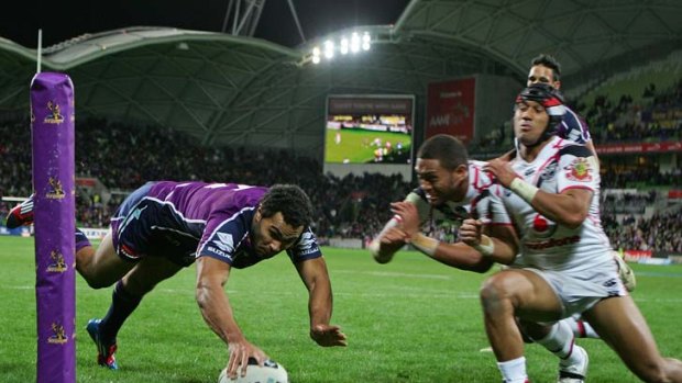 Touching down: Melbourne’s Justin O’Neill scores during the win over the Warriors.