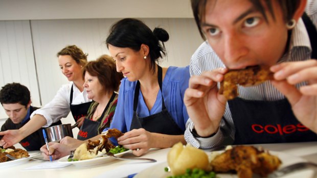 A Coles team taste tests a budget chicken meal. Home economist Jane O'Shannessy serves up the food to (from left) Brendan Buckley, Carlin Beck, Kate Rosengren  and Leigh Alexander.