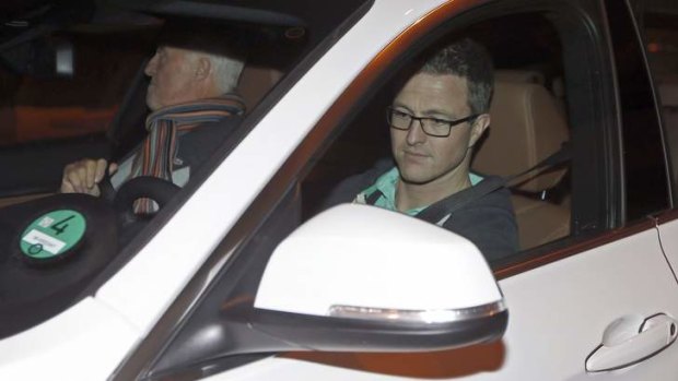 Schumacher's brother, Ralf (right), and father, Rolf, leave Grenoble hospital.