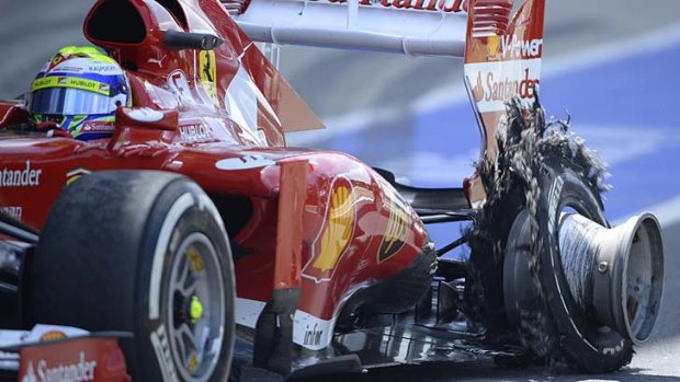 Ferrari's Brazilian driver Felipe Massa enters the pit with a puncture at the Silverstone circuit.