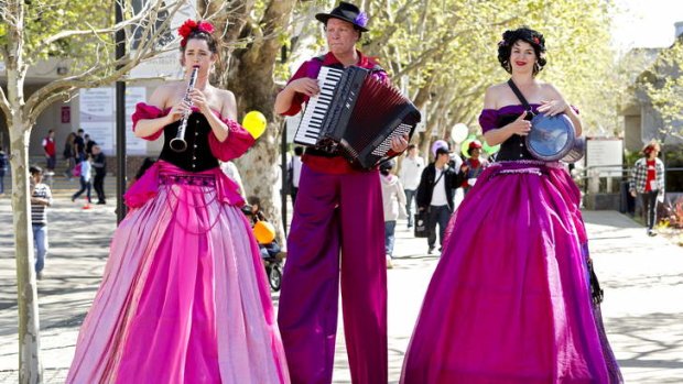 Over the top: Musicians on stilts entertain the crowds at Macquarie University.