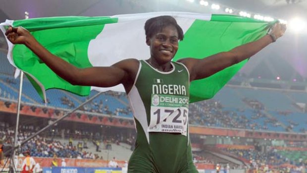 Osayemi Oludamola of Nigeria celebrates after the women's 100m final.