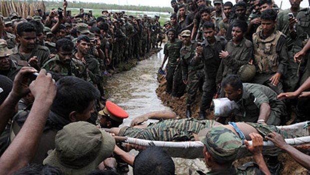 The body of Tamil Tigers leader Velupillai Prabhakaran is carried past Sri Lankan soldiers near Mullaittivu this week.