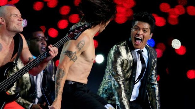 Lucrative: Bruno Mars (right) announced a tour the day after his Super Bowl half-time performance with the Red Hot Chili Peppers, while sales of his album soared.