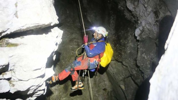 A rescuer abseils into the vast Riesending cave system.