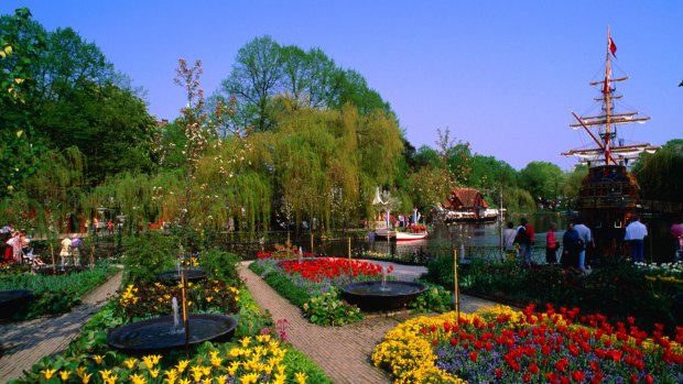 The colourful spring floral display at Tivoli Gardens in Copenhagen with the pirate ship St Georg behind.