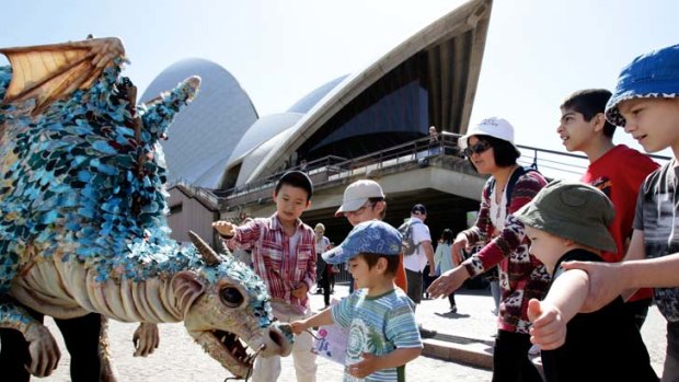 Fun day ... children test their bravery with a dragon at the Opera House open day yesterday.