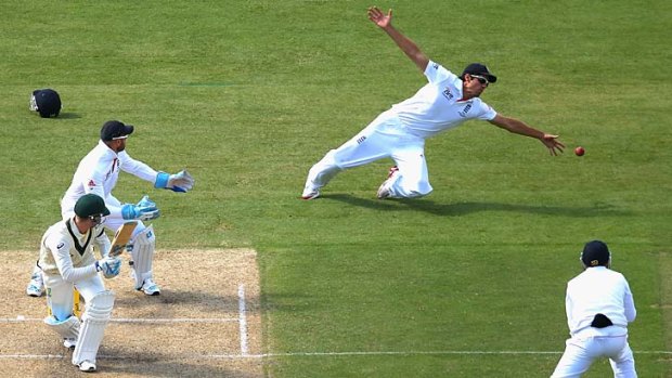 Gone begging ....  Alastair Cook dives for a ball hit by Michael Clarke.