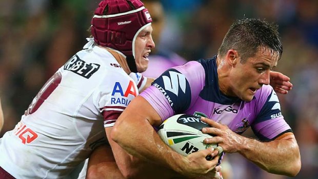 Stalemate: Cooper Cronk of the Storm is tackled by Matt Ballin of the Sea Eagles.