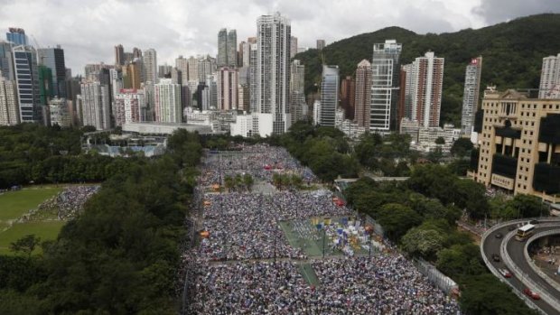 Tens of thousands of residents gather to march during an annual pro-democracy protest in Hong Kong.