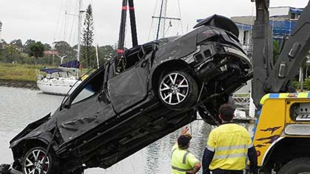 Police pull a submerged, stolen car from a canal at Raby Bay, on Brisbane’s bayside.
