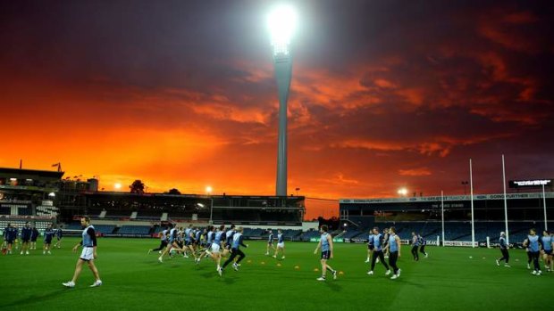 Light time: Geelong players train under lights at Simonds Stadium on Thursday night.