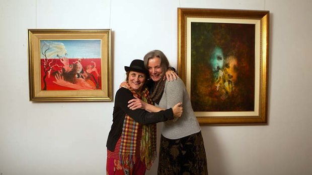 Close-knit ... Cassandra, left, and Lucinda Boyd with some of their father David's paintings.
