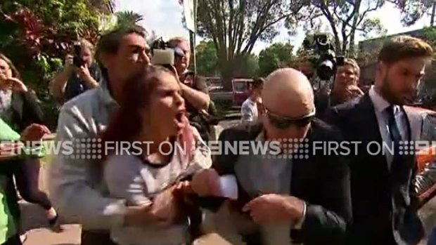 Adrian Attwater (in sunglasses) is confronted outside Grafton Local Court on August 2, 2016.