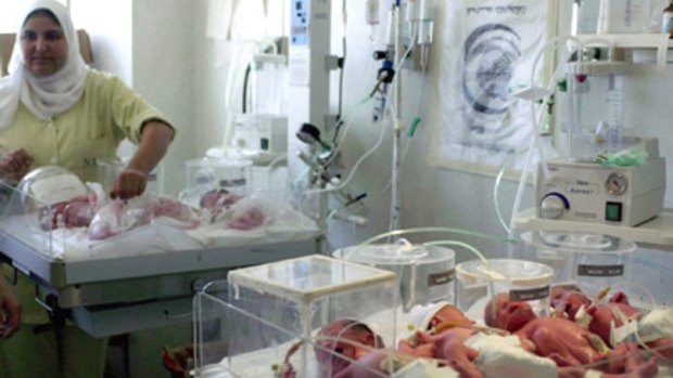 An Egyptian nurse monitors newborn septuplets of a woman who gave birth to four males and three females.