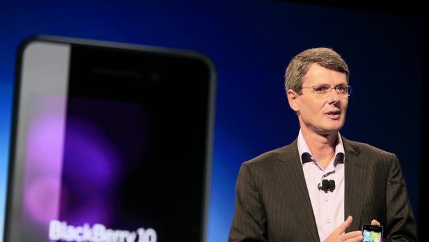 RIM CEO Thorsten Heins shows off a prototype device running the company's BlackBerry 10 software at BlackBerry World conference in Orlando, Florida.