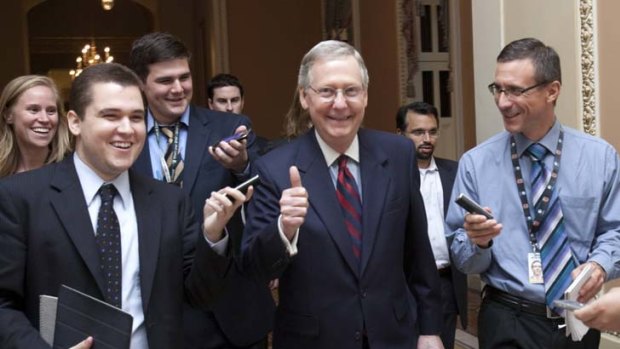 All smiles ... The Senate minority leader, Mitch McConnell, heads to the Senate floor to announce the deal has been reached.