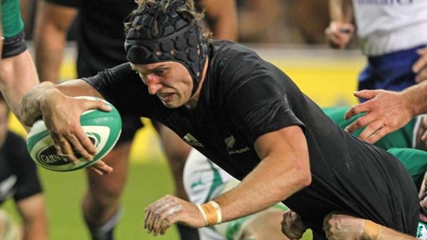 New Zealand lock Anthony Boric scores a try despite the efforts of Ireland's Sean Cronin.