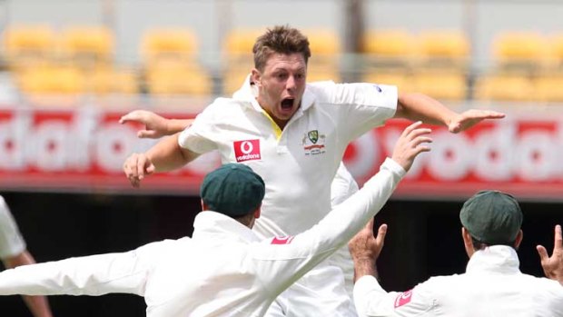 James Pattinson celebrates with teammates after dismissing New Zealand skipper Ross Taylor on day four of the first Test at the Gabba.