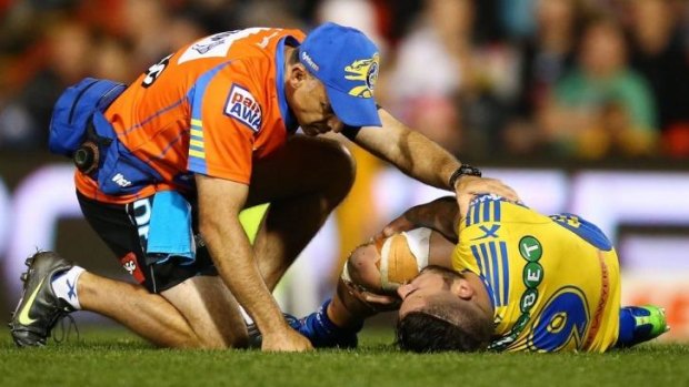 Finished for 2014: Nathan Peats' knee receives attention during Friday night's game against the Panthers.