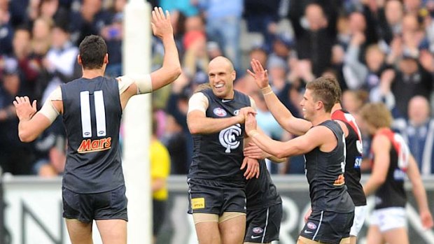 Carlton captain Chris Judd is congratulated after kicking a goal at the MCG yesterday.
