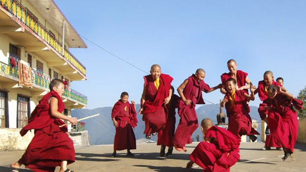 Tibetan monks play a game outside a Buddhist monastery in Shimla, India, this week at a summit of Tibetan exiles.