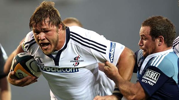 Duane Vermeulen of the Stomers is tackled by Alby Mathewson of the Blues.