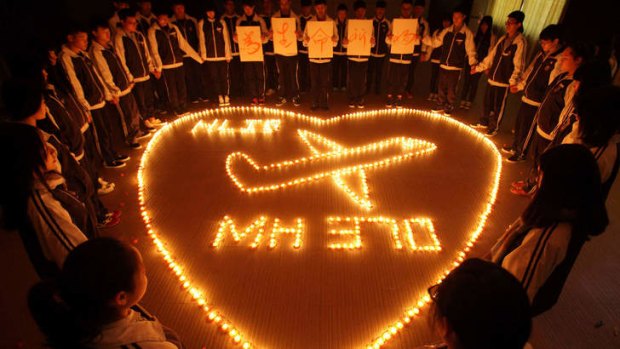 Students in China's Zhejiang province pray for the missing passengers.