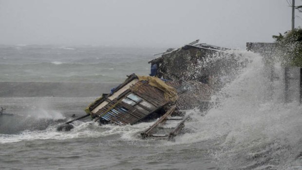 A house is engulfed by the storm surge brought about by powerful typhoon Haiyan that hit Legazpi city, Albay province.