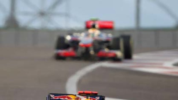 Red Bull's German driver Sebastian Vettel ahead of McLaren Mercedes' British driver Lewis Hamilton at the Yas Marina circuit.
