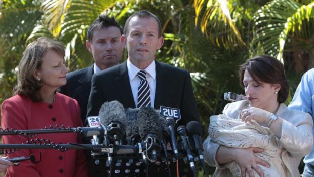 Policy dilemma ... Tony Abbott, pictured in 2010 announcing his planned changes to paid parental leave, is now under pressure to abandon the scheme.