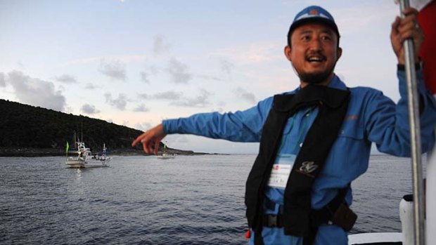 Landfall ... the Japanese politician Eiji Kosaka on a boat near the islands.