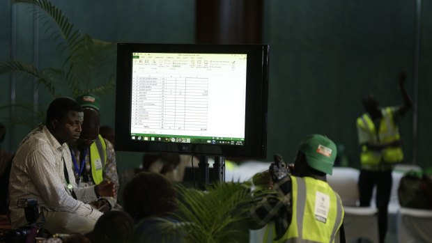 Journalists observe election results displayed on a screen in Abuja on Monday.
