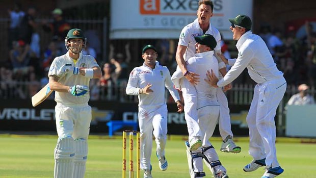 South Africa's bowler Dale Steyn, top right, celebrates with teammates after dismissing Australia's captain Michael Clarke.