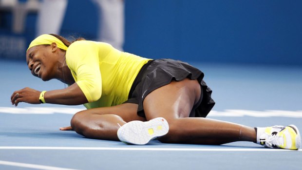 Injured: Serena Williams falls to the ground during her match against Bojana Jovanovski at the Brisbane International.