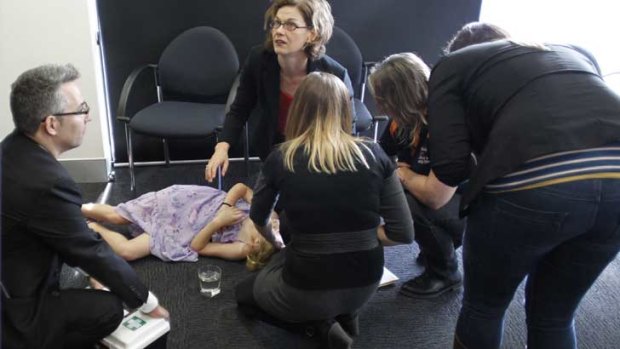 First aid is offered to a young girl who fainted at a press conference with Kevin Rudd in Perth.