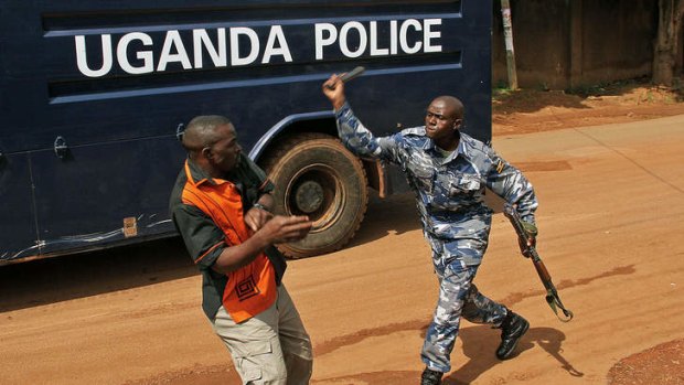 Shooting the messenger: A Ugandan policeman beats a journalist in Kampala.