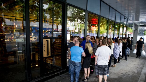 A queue of people waiting on Saturday night to take advantage of a promotional offer from new restaurant Akiba in the heart of Canberra.