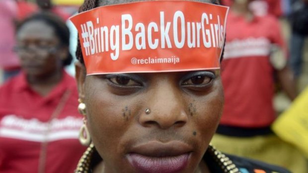 A woman with a sticker on her head bearing the slogan "Bring back our girls" marches for the release of the more than 200 abducted Chibok school girls in Lagos.